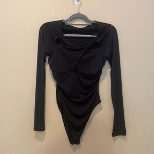 Long sleeve cross body suit. Never worn
